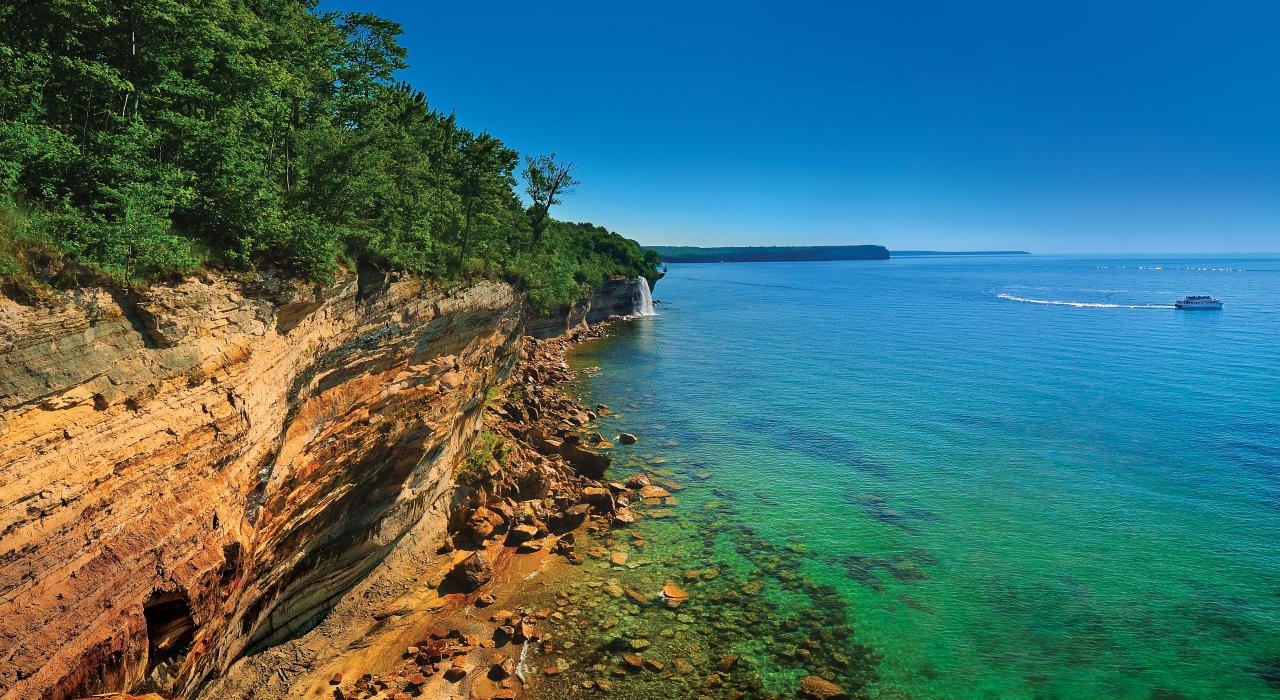 Signature sandstone cliffs hugging the shore of Lake Superior