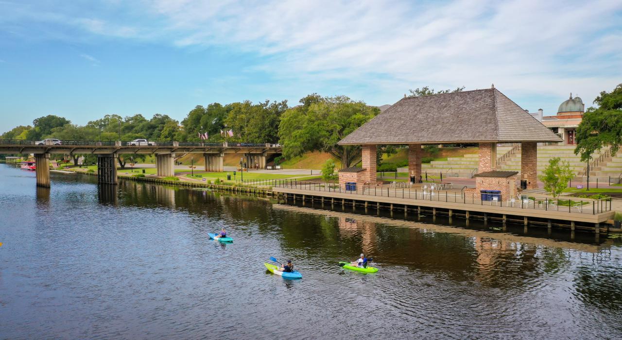 A group of kayakers paddling on the Cane River