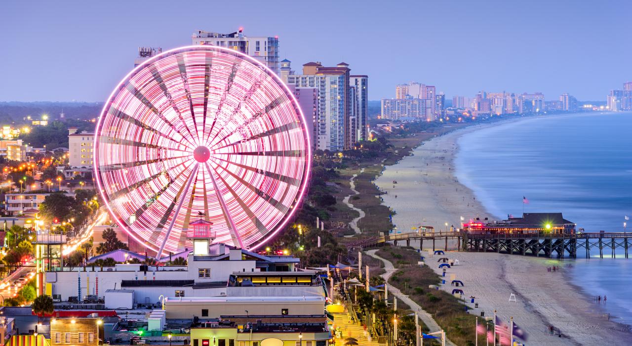 The neon-lit SkyWheel, a beacon on Ocean Boulevard