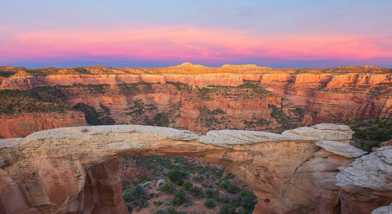 A colorful sunset over the Rattlesnake Canyon Arches