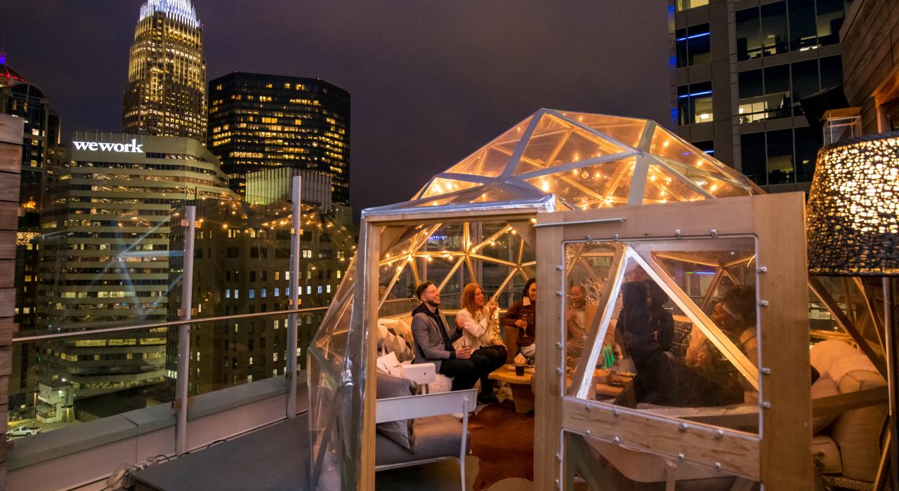 Enjoying a rooftop happy hour with views of downtown Charlotte at Merchant & Trade Enjoying a rooftop happy hour with views of downtown Charlotte at Merchant & Trade