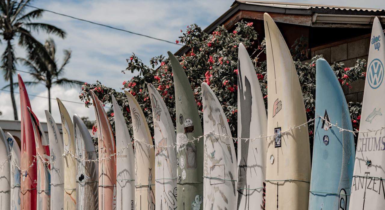 A sun-bleached palette of surfboards in Pāʻia Town