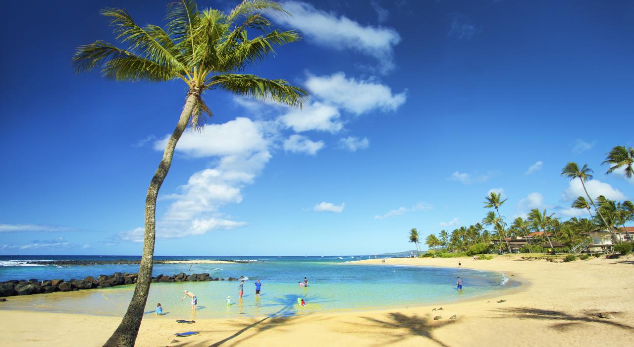 Wading in the pristine water at Poʻipū Beach Park