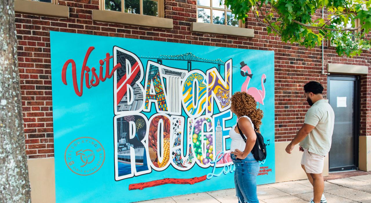 Admiring a colorful mural by local artist Kayla Newnam