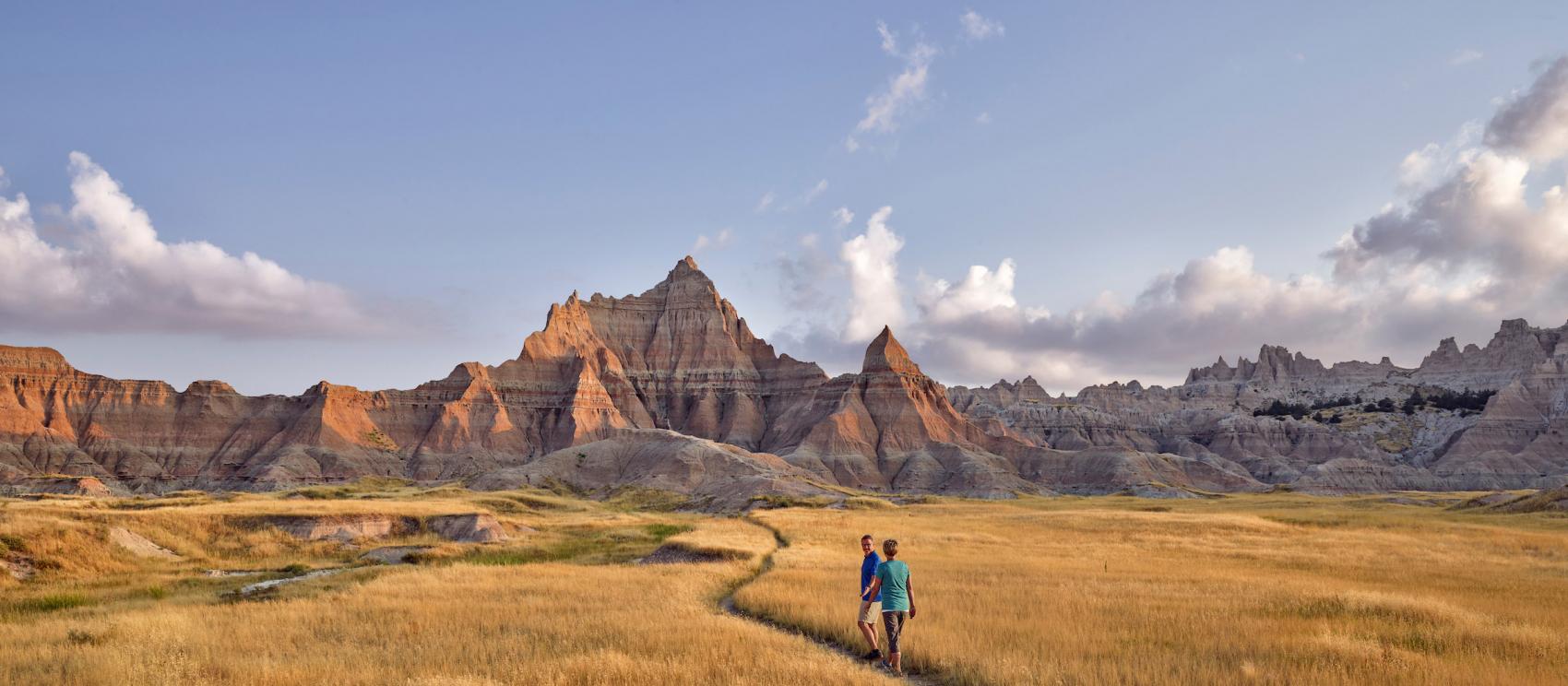 Hikers immersed in the otherworldly wilderness of Badlands National Park
