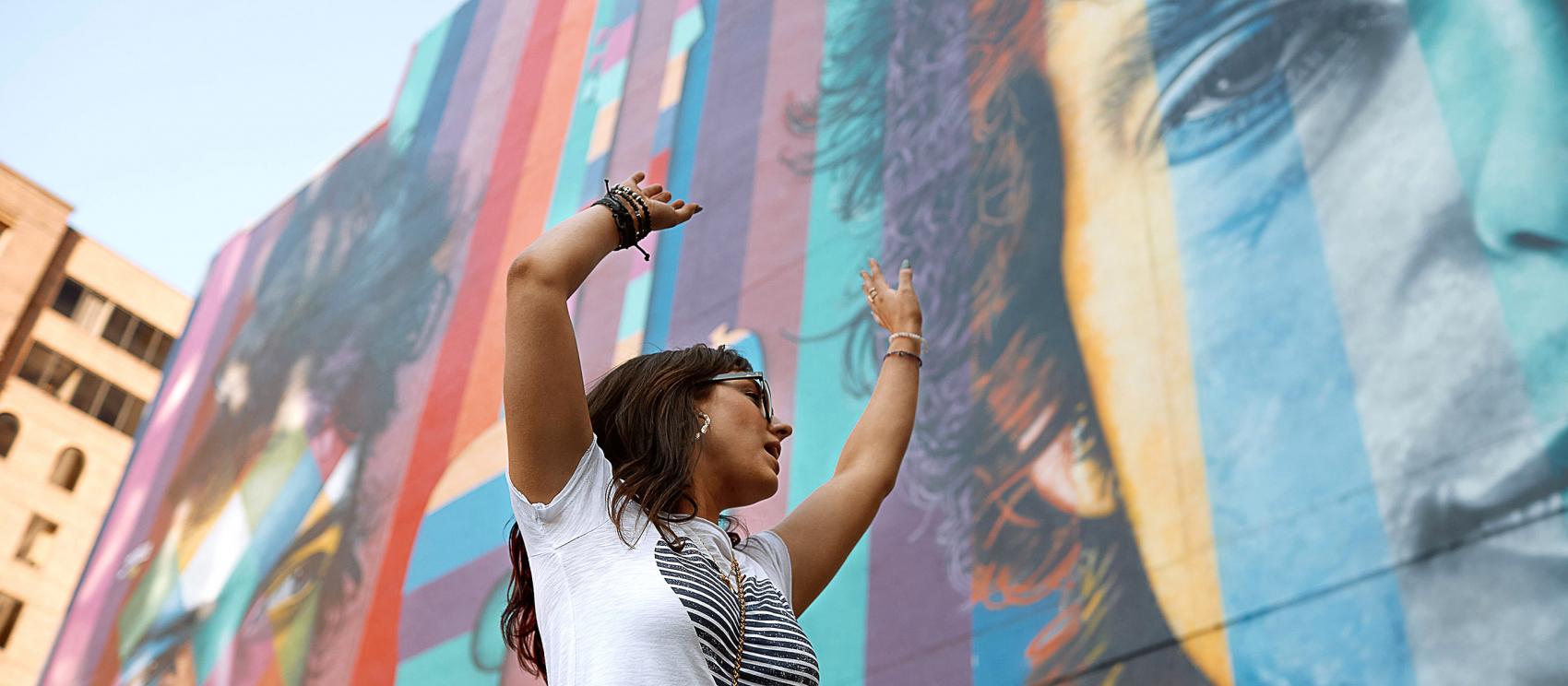 Posing with a mural celebrating Bob Dylan in Minneapolis