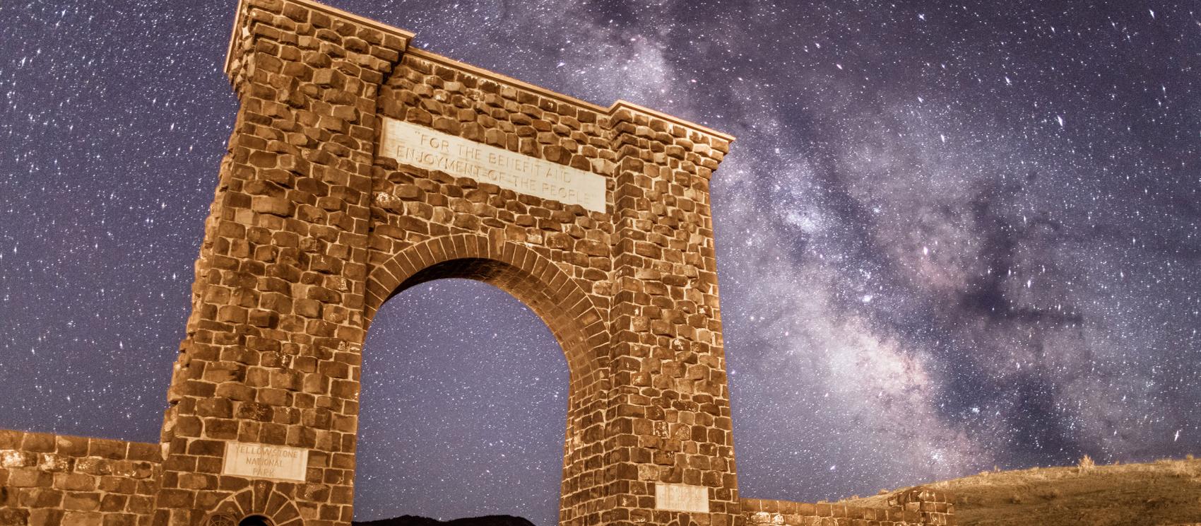 Starry skies above Roosevelt Arch, marking the Gardiner entrance to Yellowstone National Park