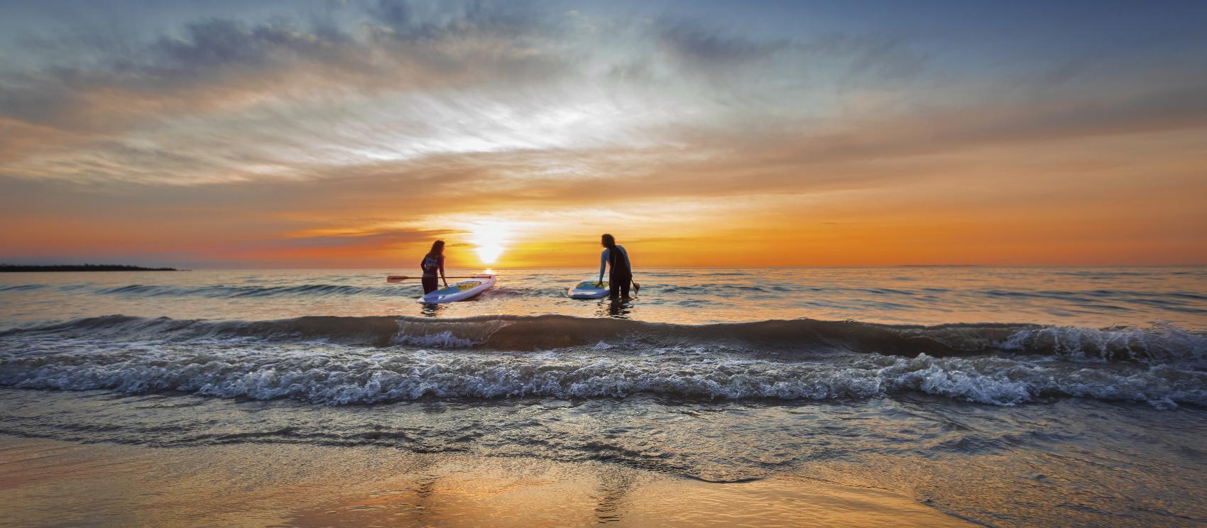 Stand-up paddleboarding at sunrise on Lake Huron in Alpena