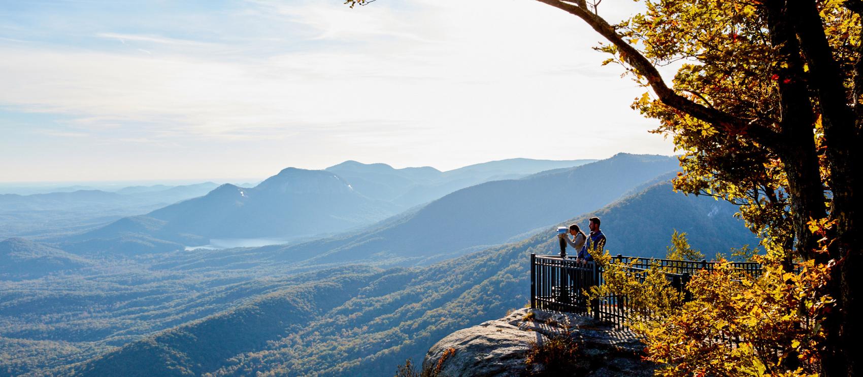 Hikers taking in scenic views from the overlook at Caesars Head State Park Hikers taking in scenic views from the overlook at Caesars Head State Park