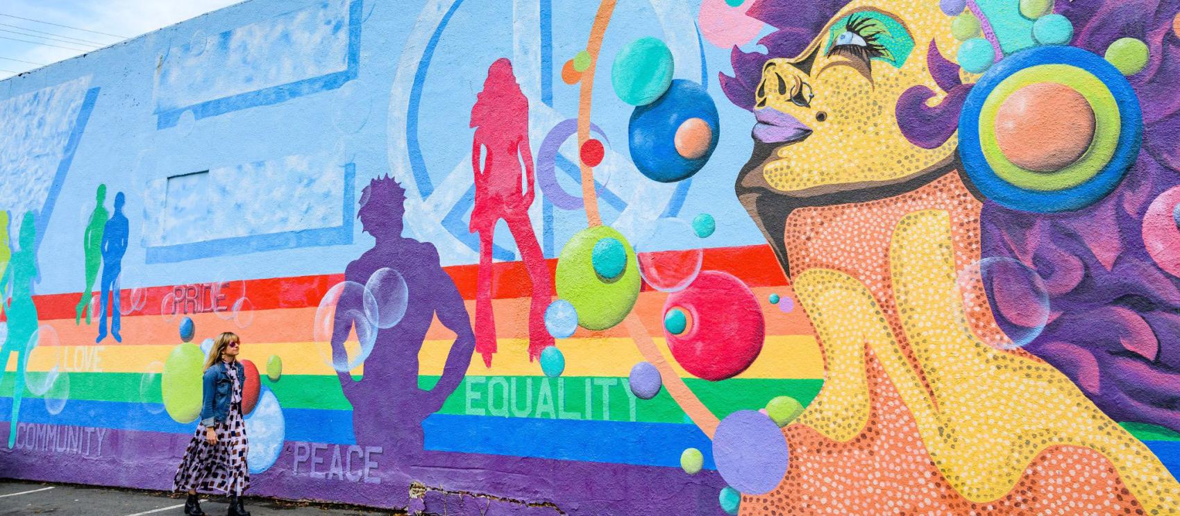 Colorful mural celebrating peace, pride and equality at Plaza Midwood in Charlotte