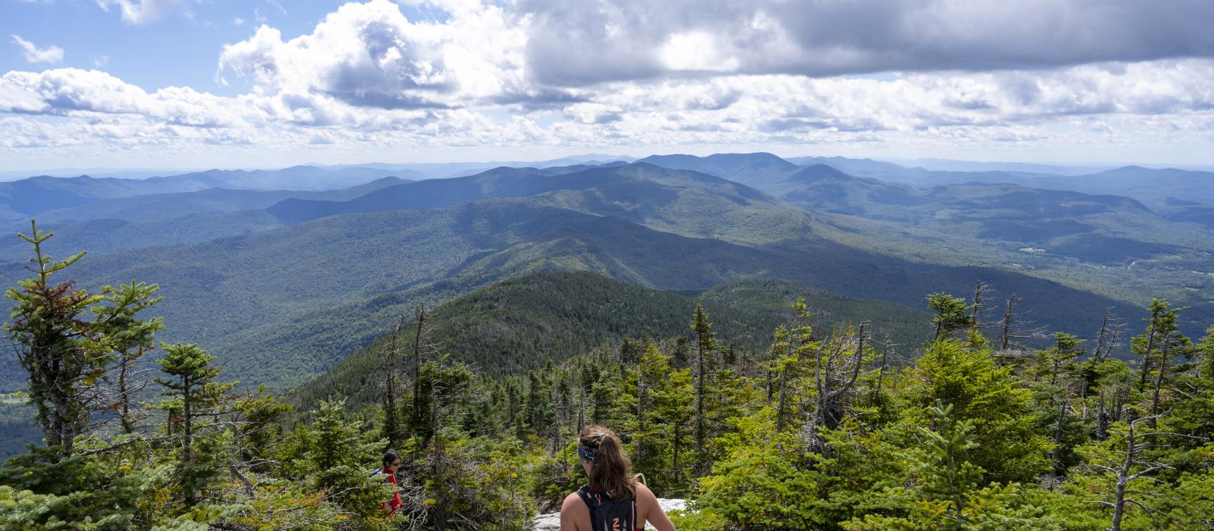 Hiker taking in the view from the 1,200-meter summit of Mount Abraham in Lincoln