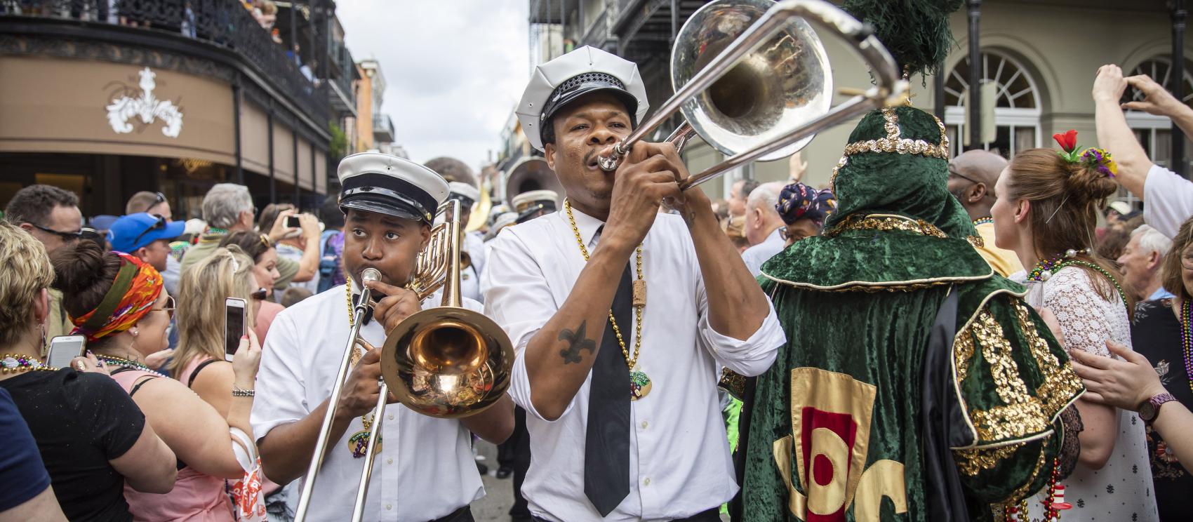 Brass musicians playing during the Krewe of Cork Mardi Gras parade in New Orleans
