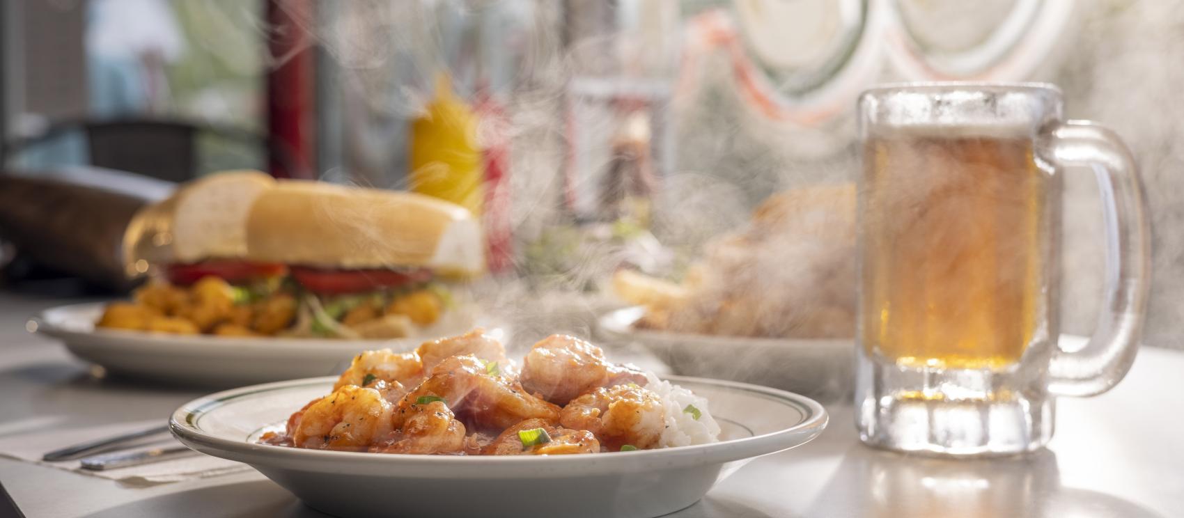 A spread of Cajun dishes and a cold beer at the Acadian Superette in Lafayette