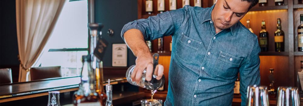 Bartender pouring bourbon at Willett Distillery in Bardstown, Kentucky